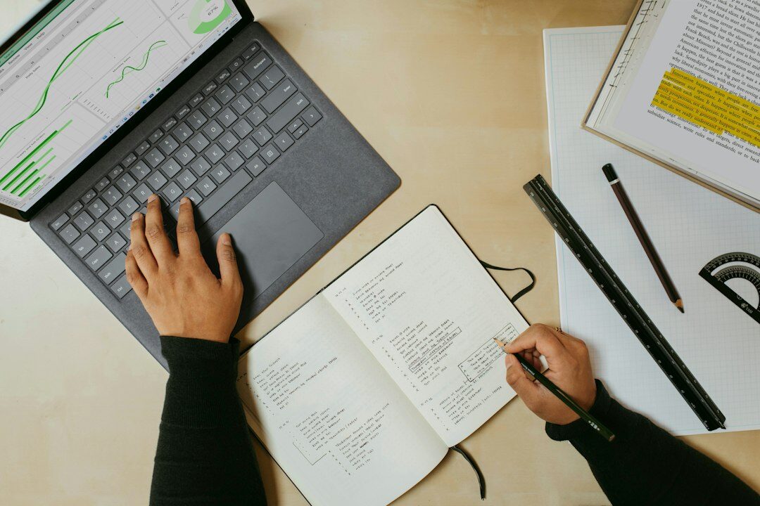 person writing in notebook
