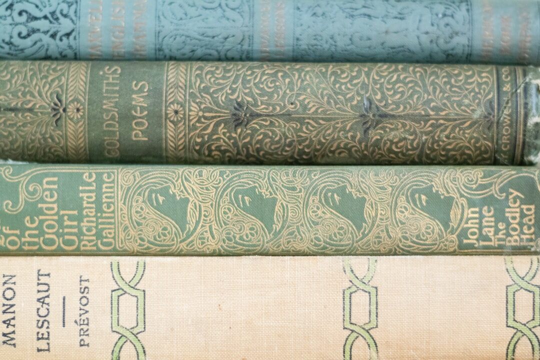 Stack of old hardcover books on a wooden table